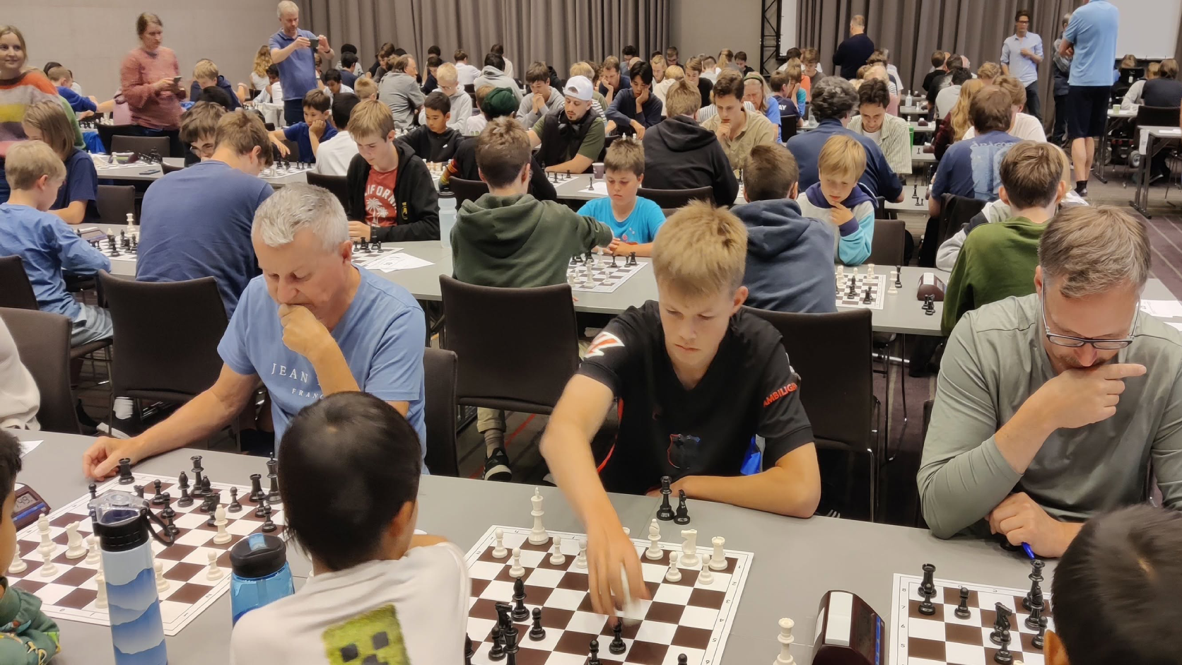 Adult members playing chess at an Eiker Sjakklubb tournament